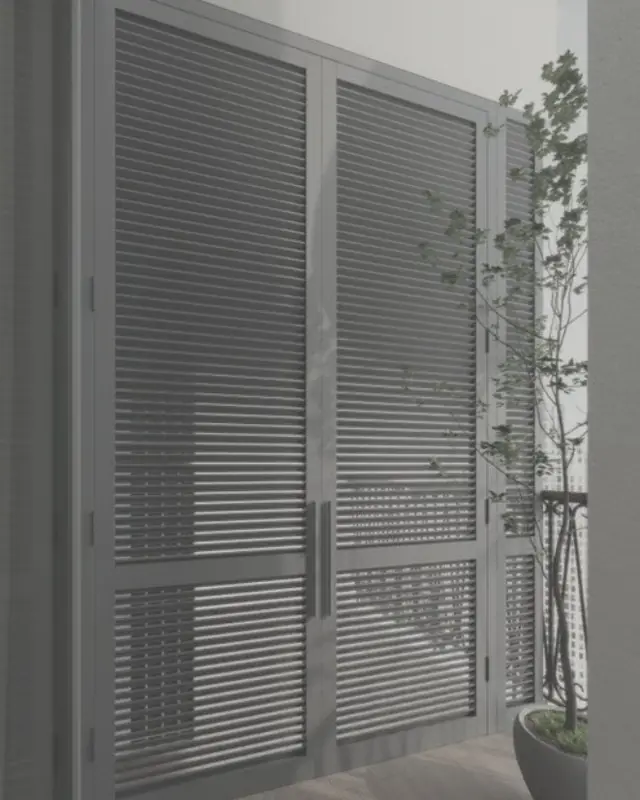 Full-height grey aluminium louvre doors closing off a balcony