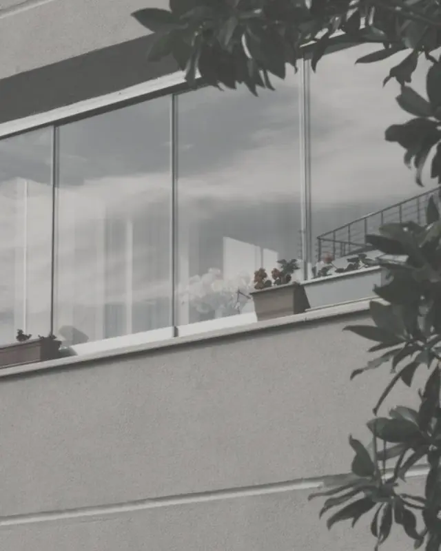 Frameless sliding glass panels across a balcony