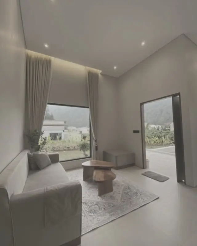 Living room with a raised cove-lit ceiling, downlights, floor tiles and a full-height window
