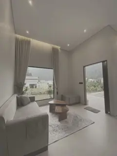 Renovated living room with a cove-lit ceiling